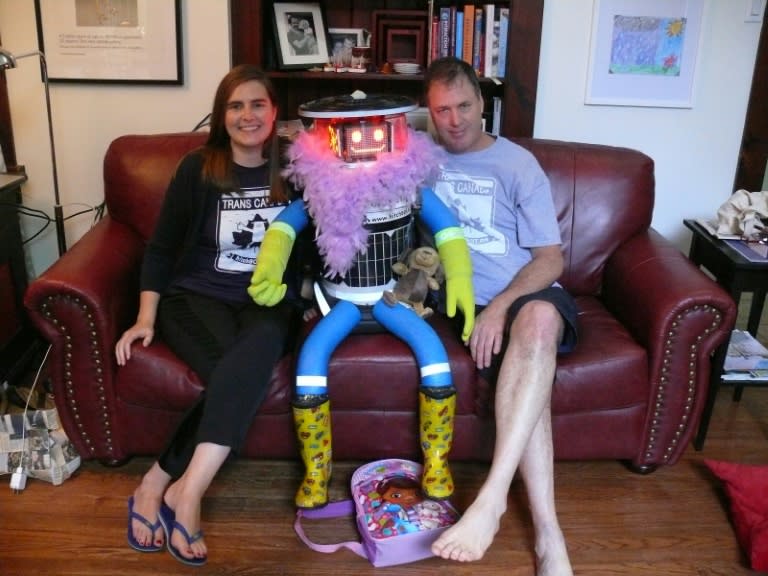 This photo obtained July 31, 2014 shows creators Dr. Frauke Zeller of Ryerson University and Dr. David Harris Smith of McMaster University with hitchBOT