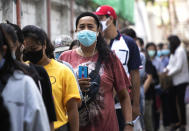 People wear face masks to help curb the spread of the coronavirus as they line up at the Social Security office for claiming unemployment benefit in Bangkok, Thailand, Thursday, June 4, 2020. Thailand's state planning agency, the National Economic and Social Development Council, estimated last week that as many as 8.4 million people could end up unemployed this year due to the COVID-19 pandemic. (AP Photo/Sakchai Lalit)