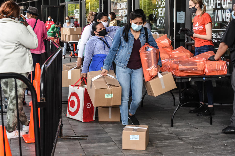 NEW YORK, NY - MAY 15: People receive a food bank donation at the Barclays Center on May 15, 2020 in the Brooklyn borough in New York City. The event was organized by Food Bank for New York City and included dairy and meat items. The sports arena in downtown Brooklyn, now closed, saw lines wrap around the block as New Yorkers struggle with unemployment and other financial stresses brought on by the COVID-19 outbreak. Across America, cities and towns are dealing with some of the highest unemployment rates since the Great Depression. (Photo by Stephanie Keith/Getty Images)