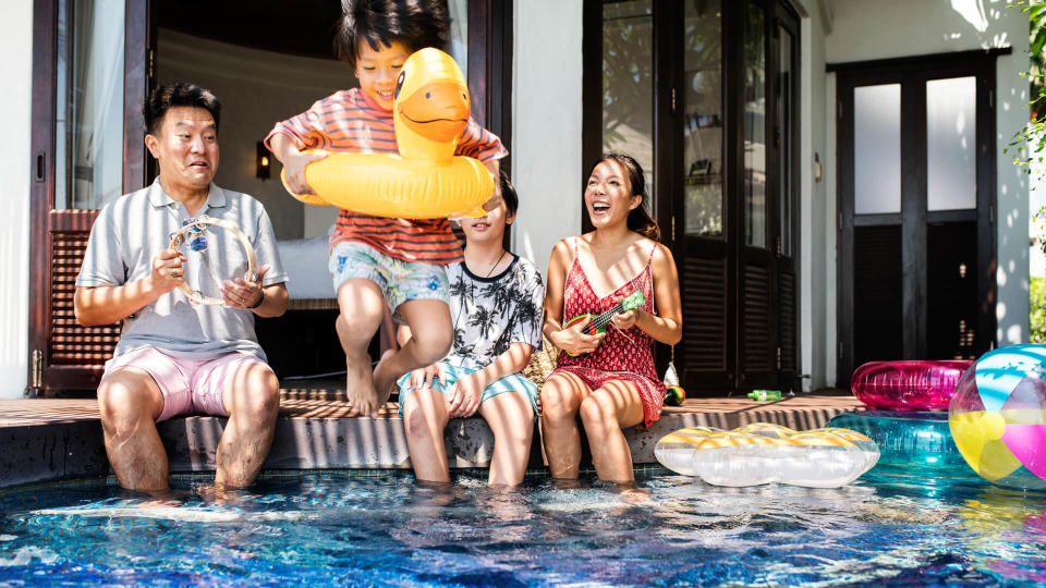 Family playing in a pool.