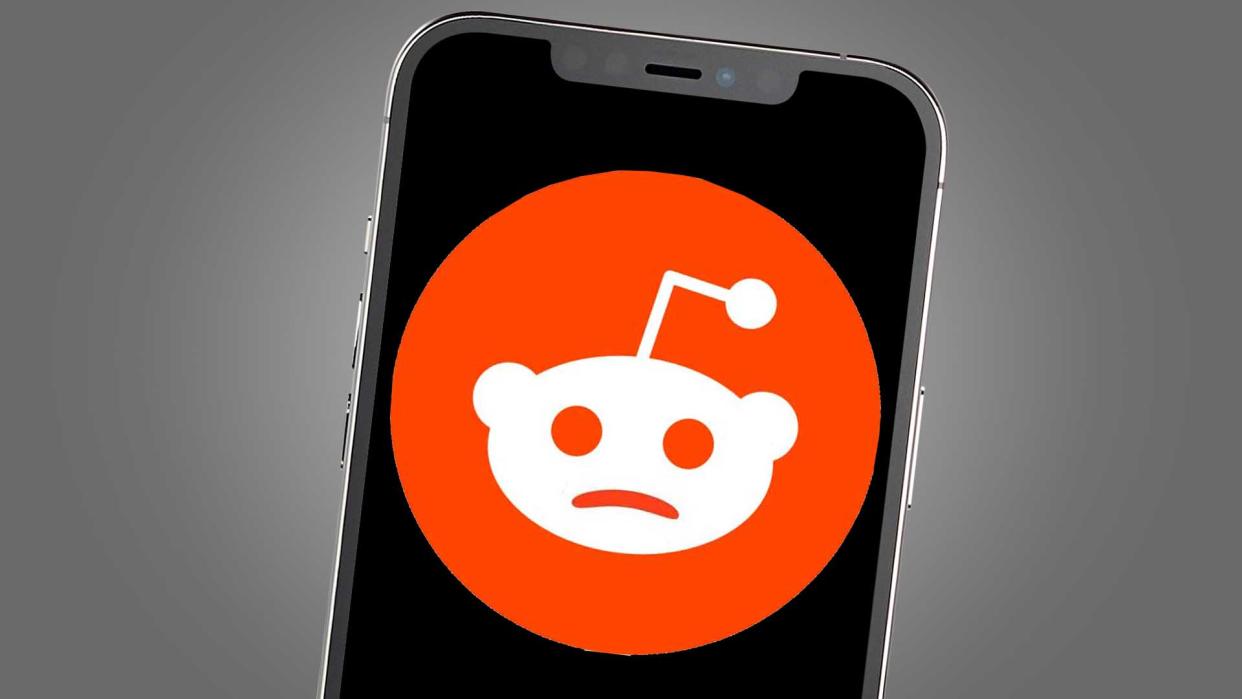  A phone screen showing a sad version of the Reddit logo. 