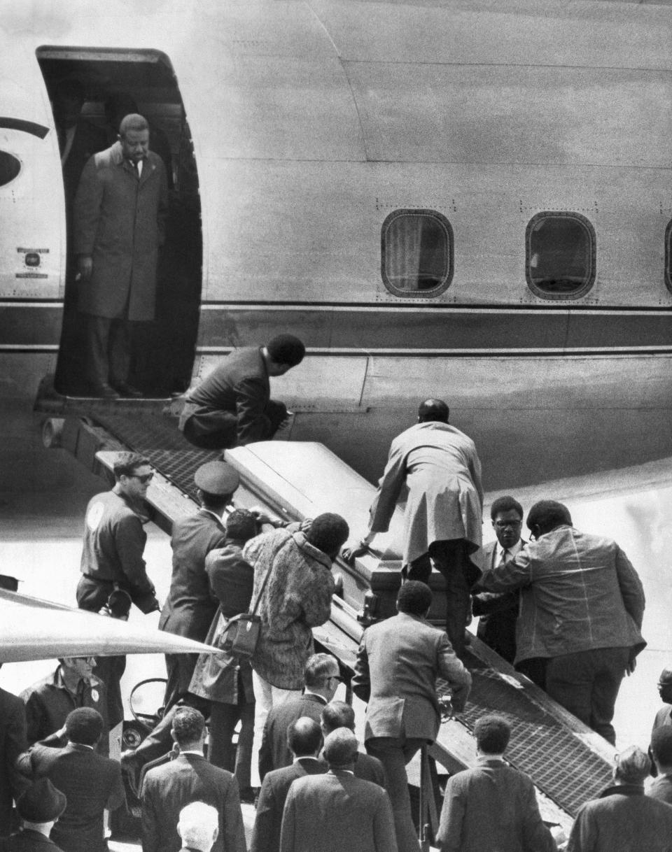 <p>The casket bearing the body of Dr. Martin Luther King, Jr., is taken up a loading ramp and placed aboard an airliner in Memphis, Tenn. for a trip to Atlanta, April 5, 1968. The Rev. Ralph Abernathy, named to replace Dr. King as head of the Southern Christian Leadership Conference, stands in the doorway of the plane. (Photo: AP) </p>