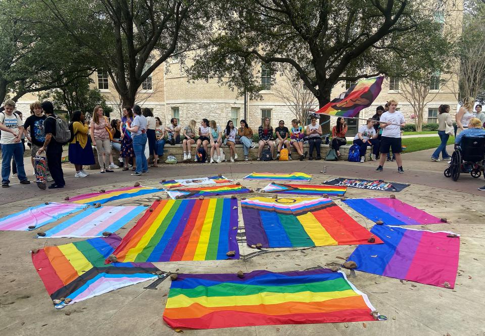 St. Edward's University students covered the university's seal in an assortment of rainbow and pride flags during Tuesday's rally.