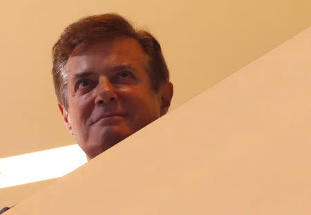 FILE PHOTO: Donald Trump's campaign manager Paul Manafort looks down from the wings of the stage as Trump celebrates below after his acceptance speech at the Republican National Convention in Cleveland, Ohio, U.S. July 21, 2016. REUTERS/Aaron P. Bernstein/File Photo