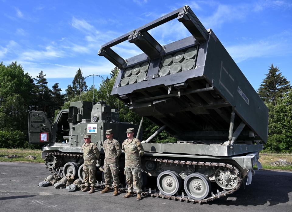 British soldiers in front of a Multiple Launch Rocket System