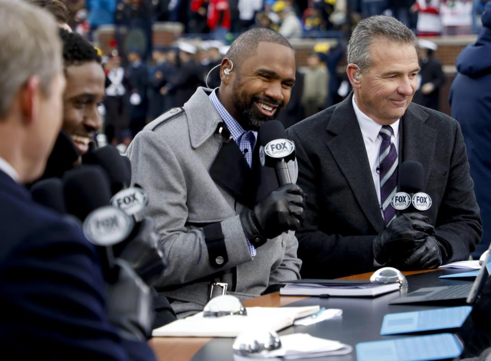 Analyst Charles Woodson, left, and former Ohio State coach Urban Meyer chat during a broadcast of Fox Sports' "Big Noon Kickoff" before the Ohio State-Michigan game in 2019. The loss of the 2020 season will cost Ohio State tens of millions in TV revenue.