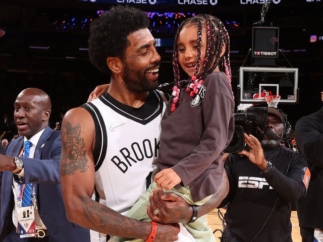 <p>Nathaniel S. Butler/NBAE/Getty </p> Kyrie Irving with his daughter, Azurie Elizabeth Irving, after a game in 2022.