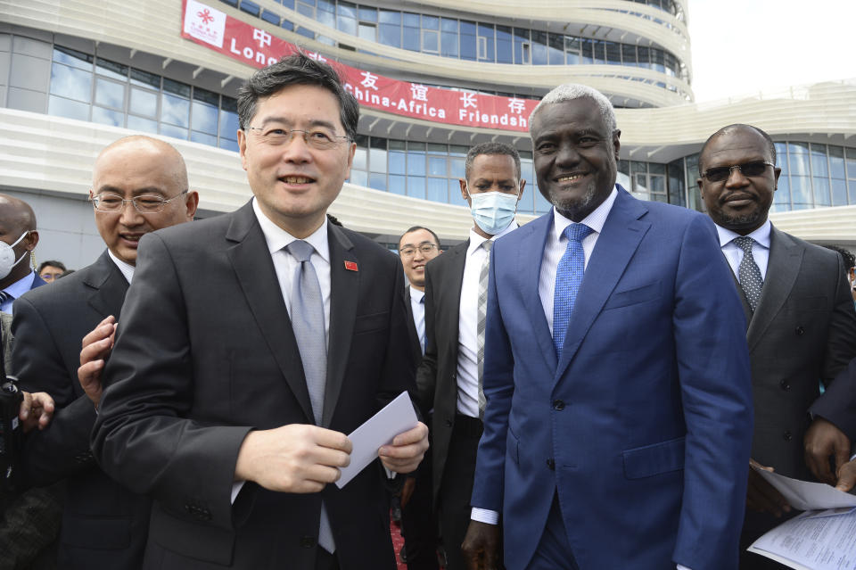FILE - China's Foreign Minister, Qin Gang, left, and African Union Commission (AUC) chair Moussa Faki Mahamat, right, attend the inauguration of the Africa Centers for Disease Control and Prevention (Africa CDC) in Addis Ababa, Ethiopia, on Jan. 11, 2023. China has removed outspoken foreign minister Qin Gang from office and replaced him with his predecessor, Wang Yi. In an announcement on Tuesday, July 25, 2023, state media gave no reason for Qin’s removal, but it comes after he dropped out of sight almost one month ago amid speculation over his personal affairs and political rivalries.(AP Photo, File)