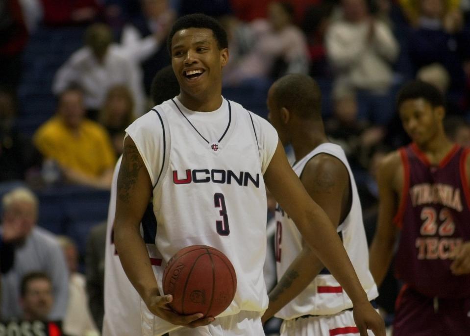 Connecticut's Caron Butler holds the ball and smiles as he walks off the floor after Connecticut defeated Virginia Tech 85-72 at Gampel Pavilion on the UConn campus in Storrs, Conn., Saturday, Feb. 3, 2001.