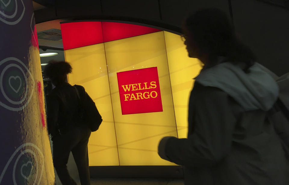 In this Thursday, Oct. 13, 2016, file photo, commuters walk by a Wells Fargo ATM location at New York’s Penn Station. AP Photo/Swayne B. Hall, File