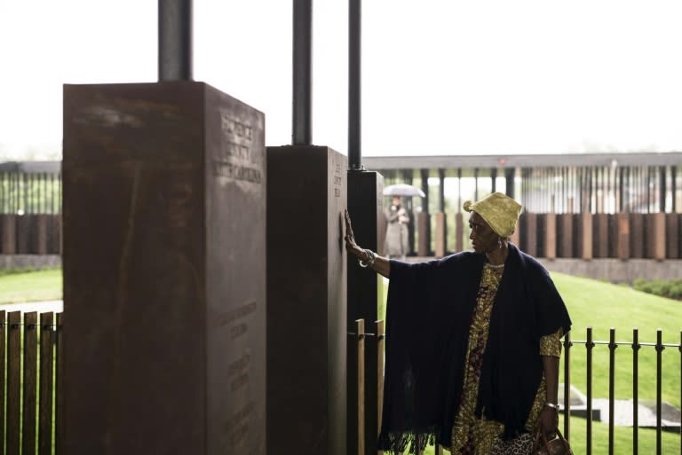 Wretha Hudson, 73, examines a monument recording lynchings in Lee County, Texas, one of 800 such markers at the National Memorial For Peace and Justice