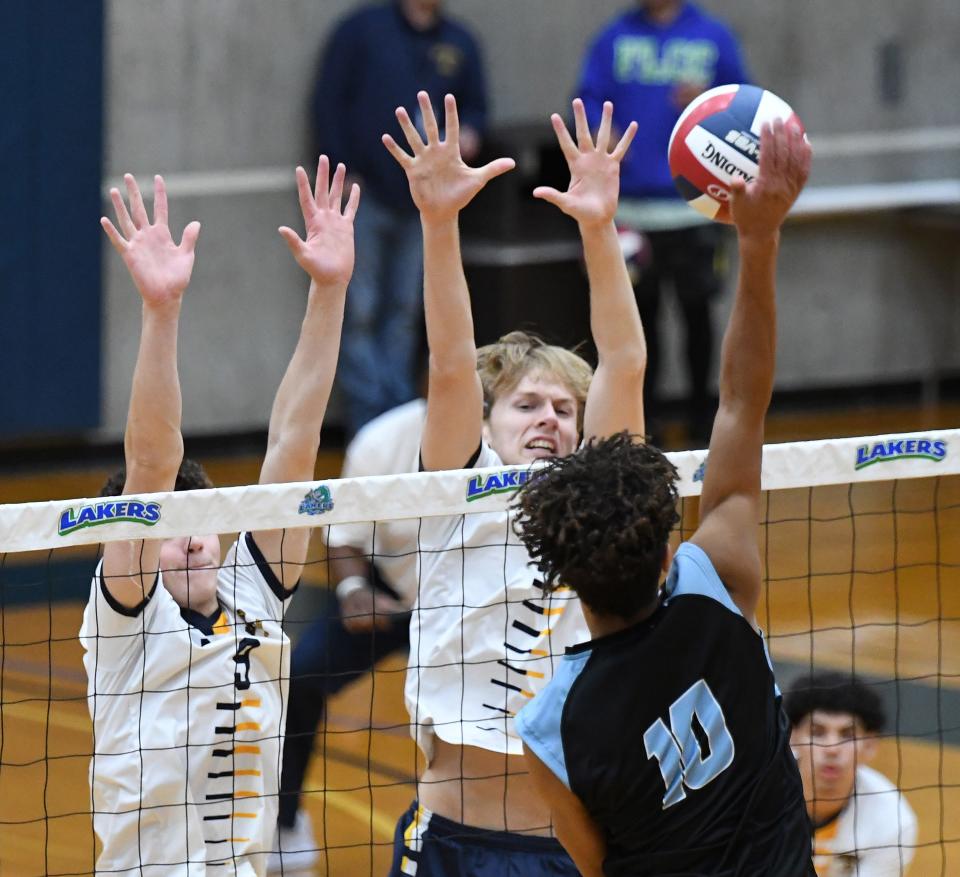 Bailey Zambuto and Collin Auburn of Spencerport go up for a block attempt against Aiden Bryant of Midlakes.