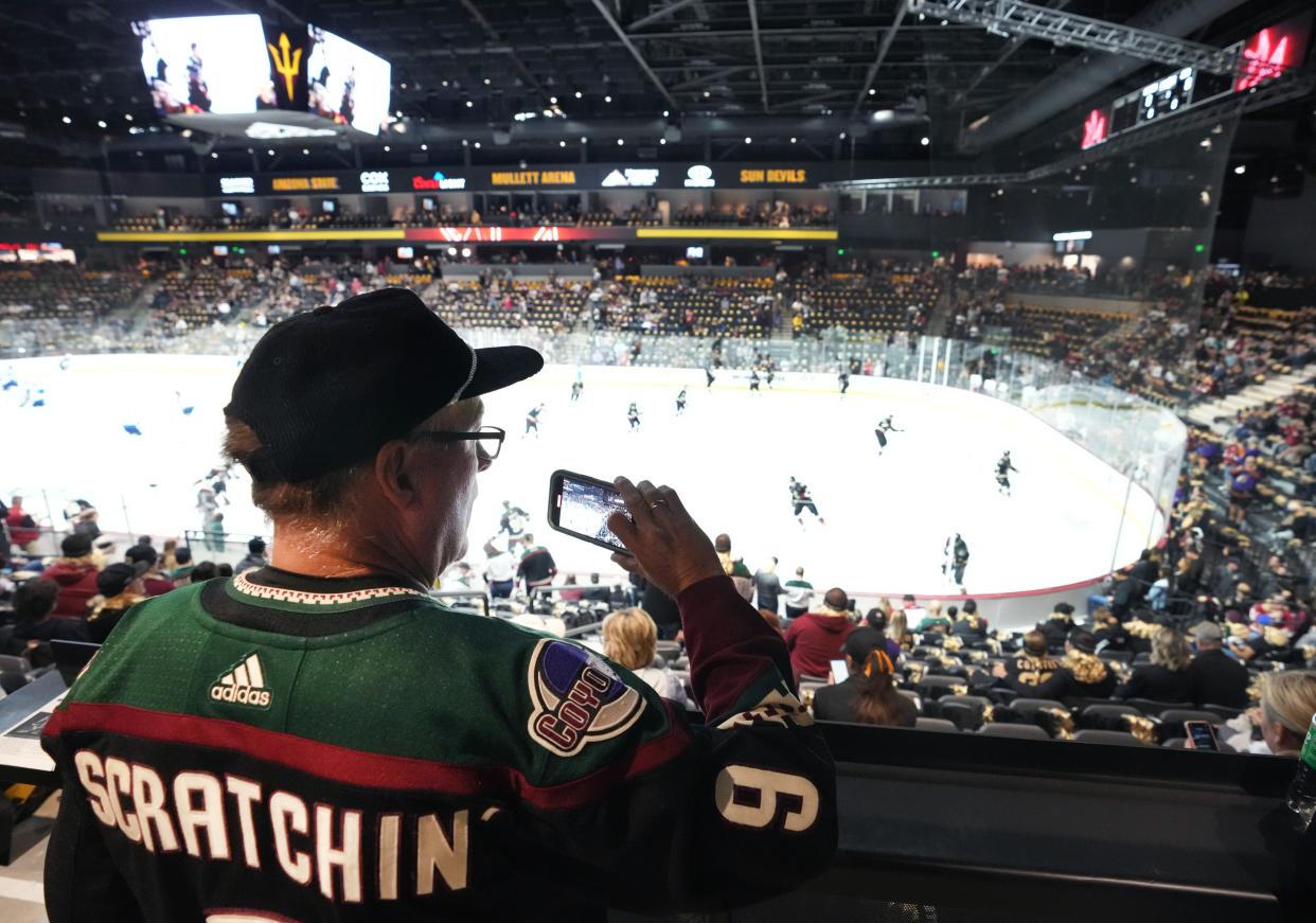 Oct 28, 2022; Tempe, AZ, USA; Doug Fry records the Phoenix Coyotes as they take the ice to play the Winnipeg Jets at Mullett Arena. Mandatory Credit: Joe Rondone-Arizona Republic