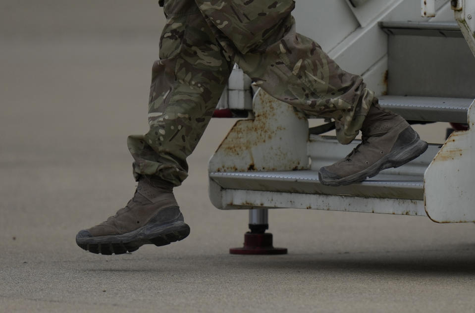 Members of the British armed forces 16 Air Assault Brigade walk to the air terminal after disembarking a RAF Voyager aircraft at Brize Norton, England, as they return from helping in operations to evacuate people from Kabul airport in Afghanistan, Saturday, Aug. 28, 2021. More than 100,000 people have been safely evacuated through the Kabul airport, according to the U.S., but thousands more are struggling to leave in one of history's biggest airlifts. (AP Photo/Alastair Grant, Pool)