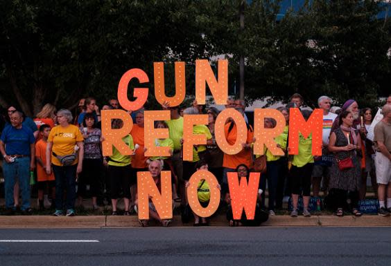 Gun control advocates take part in a candlelit vigil outside the NRA headquarters in Fairfax, Virginia (Getty)