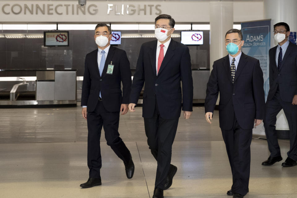 In this photo released by Xinhua News Agency, China's new Ambassador to the United States Qin Gang, second from left, arrives in the United States to assume office on Wednesday, July 28, 2021. Qin outlined the challenges the two countries face in what has become an increasingly competitive and contentious relationship, while refraining from any criticism in short remarks after arriving to take up his new post. (Wang Ying/Xinhua via AP)