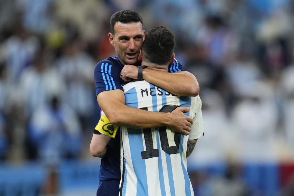 Argentina's head coach Lionel Scaloni embraces Argentina's Lionel Messi at the end of the World Cup quarterfinal soccer match between the Netherlands and Argentina, at the Lusail Stadium in Lusail, Qatar, Saturday, Dec. 10, 2022. (AP Photo/Natacha Pisarenko)