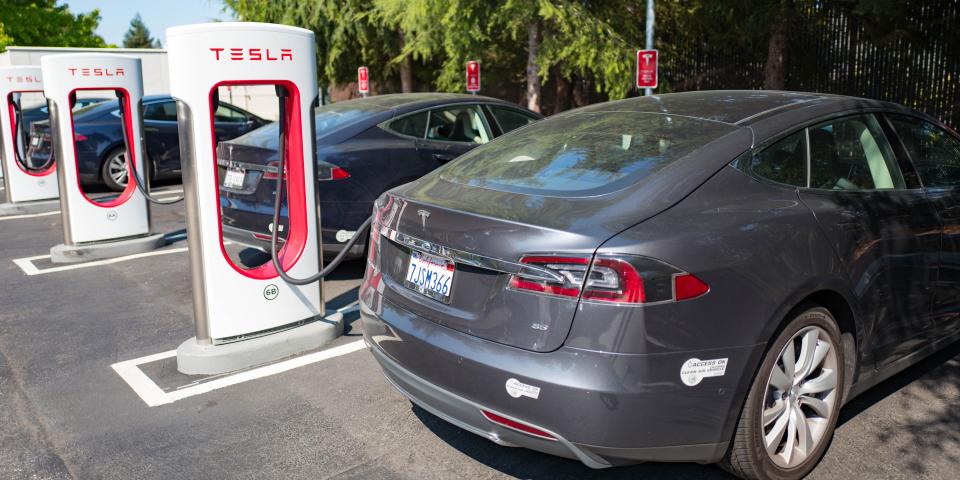 Tesla vehicles plugged in and charging at a Supercharger rapid battery charging station for the electric vehicle company Tesla Motors, in the Silicon Valley town of Mountain View, California, August 24, 2016.