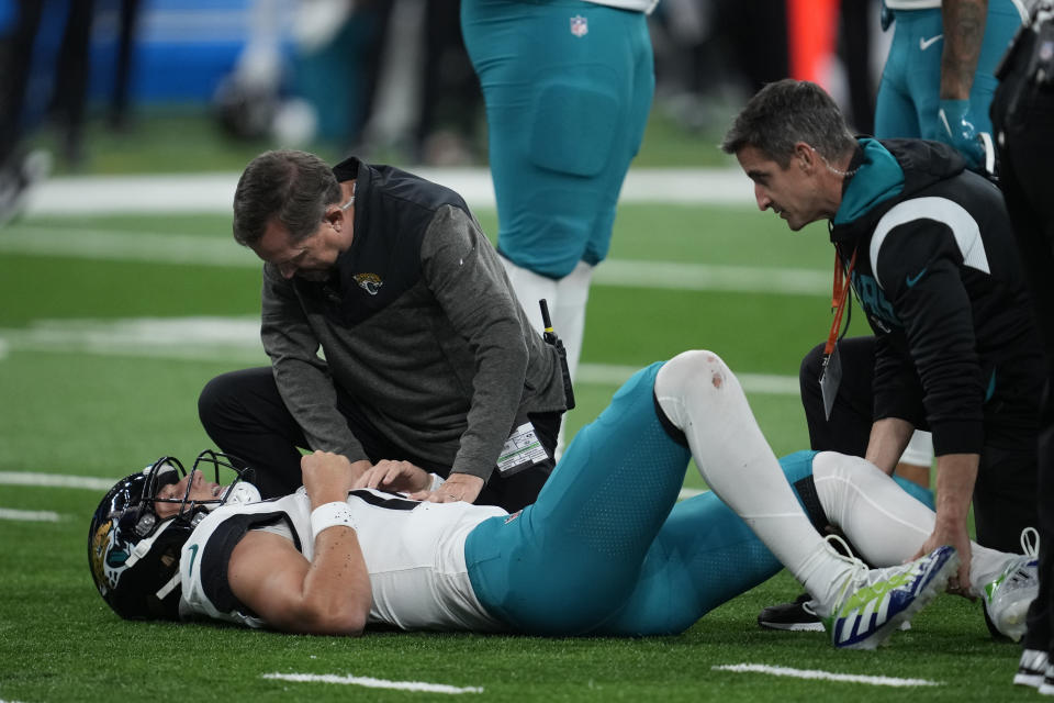 Jacksonville Jaguars quarterback Trevor Lawrence is examined during the first half of an NFL football game against the Detroit Lions, Sunday, Dec. 4, 2022, in Detroit. (AP Photo/Paul Sancya)