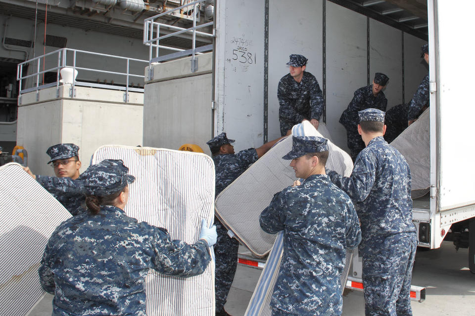 In this Oct. 15, 2012 photo provided by the U.S. Navy, sailors from USS Abraham Lincoln load used mattresses onto a truck to be recycled at Pier 11 Naval Station in Norfolk, Va. The mattresses from two Virginia-based aircraft carriers and an amphibious transport dock are having their parts recycled by a South Carolina company this year for other uses. In all, the Navy plans to recycle 13,000 mattresses from the USS Enterprise, USS Abraham Lincoln and USS Mesa Verde as part of a pilot program run by Naval Facilities Engineering Command Mid-Atlantic's Integrated Solid Waste. (AP Photo/U.S. Navy, John Land)