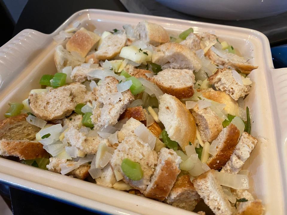 Ina Garten's stuffing spread out in a white baking dish