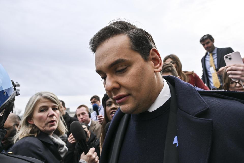 Former Rep. George Santos of New York is swarmed by media while leaving the Capitol in Washington, D.C., in December.