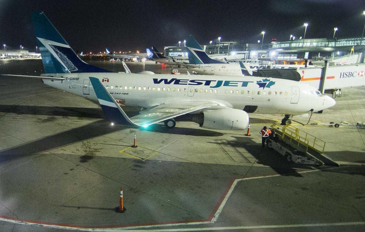 TORONTO, March 25, 2020. Passenger planes of WestJet are seen at Pearson International Airport in Toronto, Canada, March 24, 2020. Canada's second largest airline WestJet on Tuesday announced to lay off 6,900 employees due to the impact of the COVID-19 pandemic. Nearly two-thirds of the airline's fleet of 120 aircrafts are currently grounded. (Photo by Zou Zheng/Xinhua via Getty) (Xinhua/Zou Zheng via Getty Images)