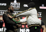 Tyson Fury, of England, right, shoves Deontay Wilder during a face off for photographers at a news conference for their upcoming WBC heavyweight championship boxing match, Wednesday, Feb. 19, 2020, in Las Vegas. (AP Photo/Isaac Brekken)
