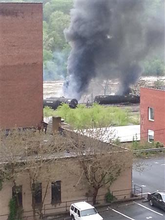 Smoke rises from a CSX Corp train carrying crude oil that derailed and burst into flames in downtown Lynchburg, Virginia, April 30, 2014. REUTERS/WSET/Handout via Reuters