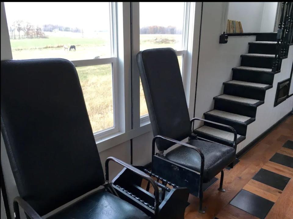 Original conductor chairs from 1973 featured inside a train caboose-turned-Airbnb.