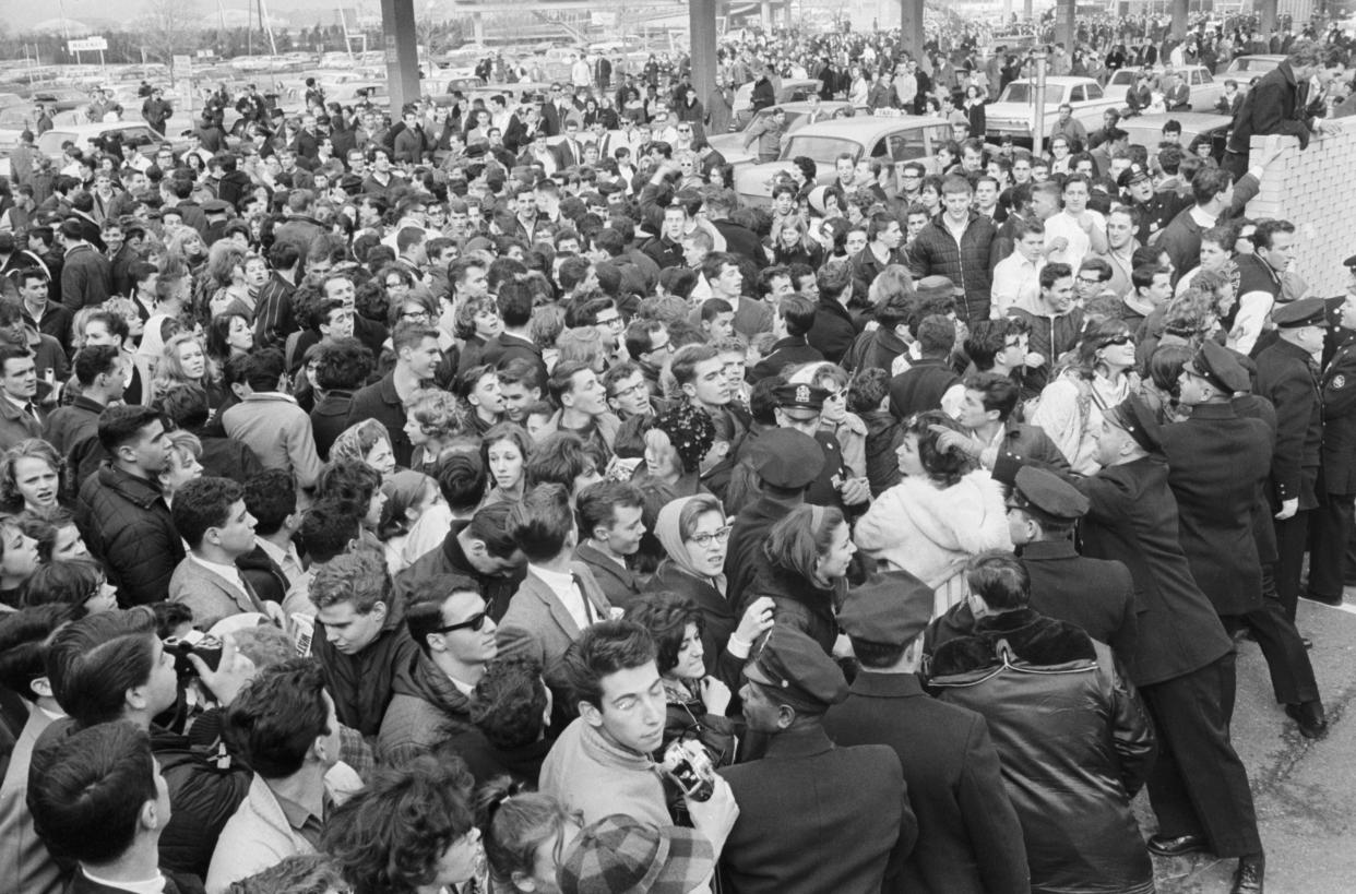 New York City police officers try to contain several hundred Beatles fans 