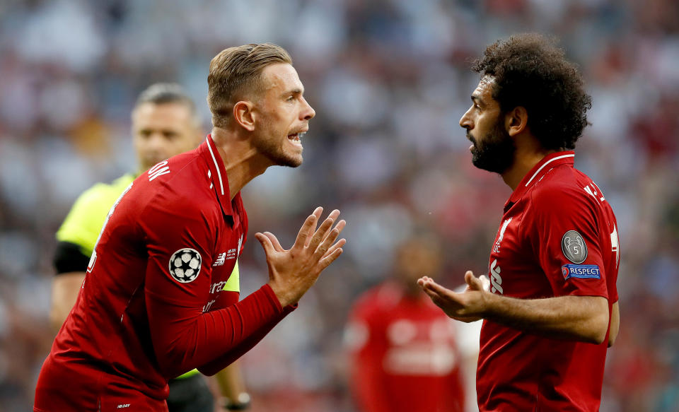 Liverpool's Jordan Henderson (left) and Mohamed Salah (right) exchange words during the UEFA Champions League Final at the Wanda Metropolitano, Madrid.