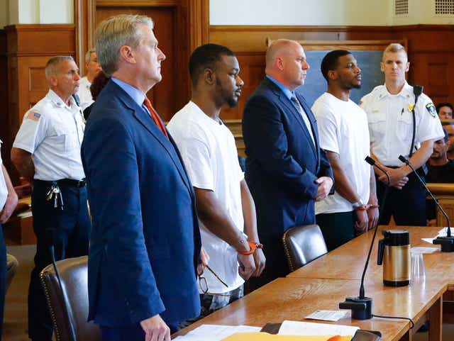 Kentavious Coleman and Kenyonte Galmore, standing with their lawyers, are accused of murder in the slaying of 19-year-old Reina Rodriguez, of Lowell, at a Braintree hotel.