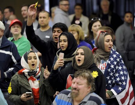 Young Muslims protest against U.S. Republican presidential candidate Donald Trump before being escorted out during a campaign rally in the Kansas Republican Caucus at the Century II Convention and Entertainment Center in Wichita, Kansas March 5, 2016. REUTERS/Dave Kaup/File Photo