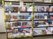 Various challenged books are surrounded by caution tape at the White Rose Books & More bookstore in Kissimmee, Fla. on Wednesday, May 22, 2024. (Erin Decker/White Rose Books & More via AP)