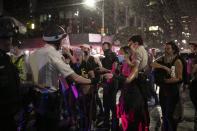 Police advance to arrest some protesters after they broke a curfew Wednesday, June 3, 2020, in New York, by marching through Manhattan during a solidarity rally calling for justice over the death of George Floyd. Floyd died after being restrained by Minneapolis police officers on May 25. (AP Photo/Wong Maye-E)