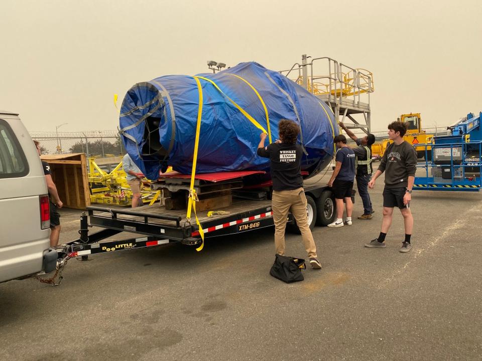 Wallenpaupack Aeronautical Science & Aviation (WASA) students help secure the jet engine turbine donated by JetBlue for the trip back from JFK International Airport to Wallenpaupack Area High School in June of 2023.