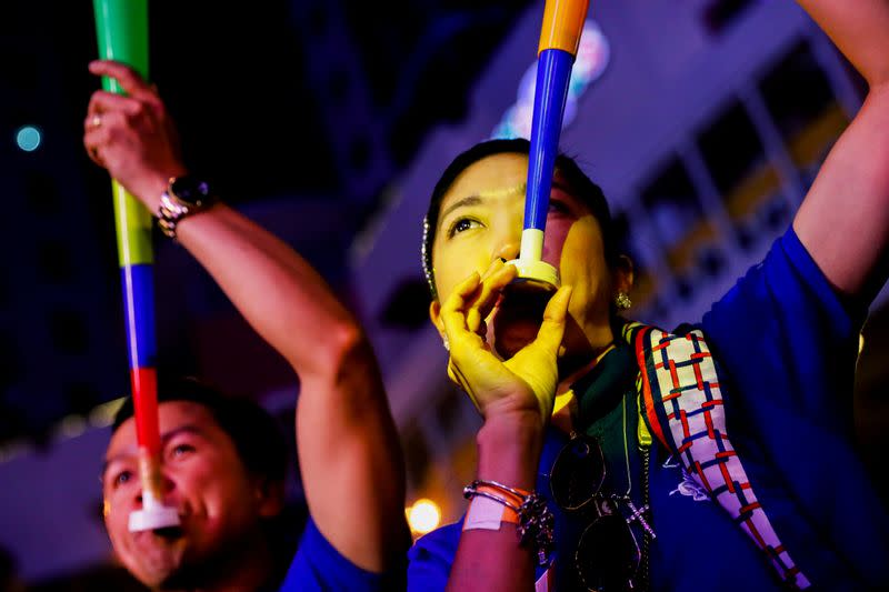 A reveller blows a plastic horn during a New Year's Eve party in Quezon City, Metro Manila