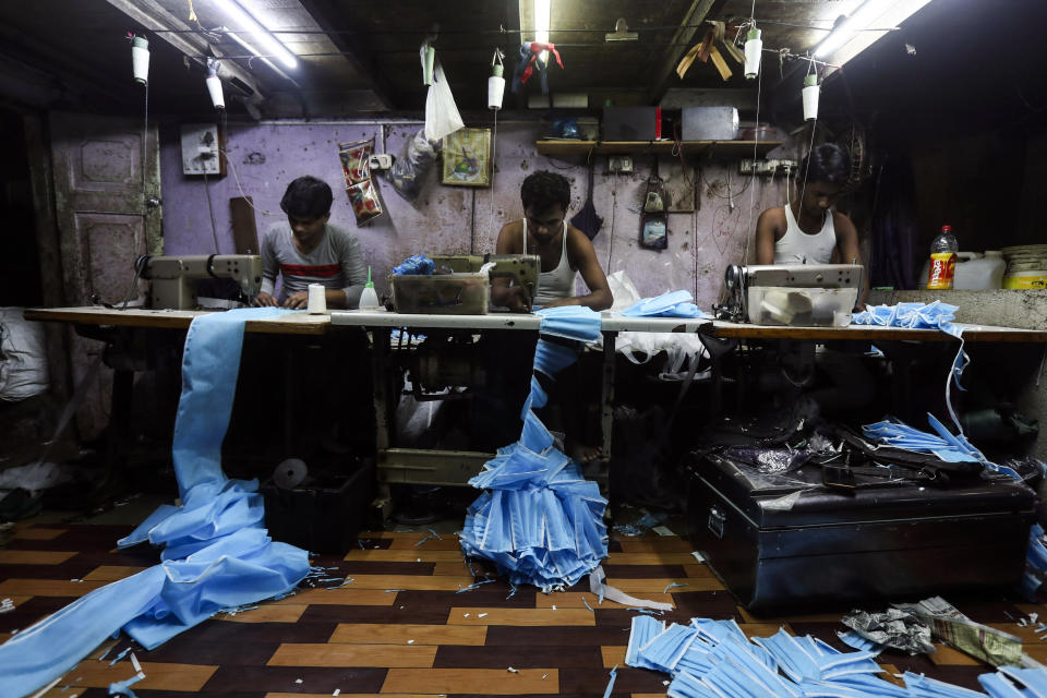 Indian workers make face masks which are in demand due to the coronavirus at a private manufacturing unit in Mumbai, India, Tuesday, March 17, 2020. (AP Photo/Rafiq Maqbool)