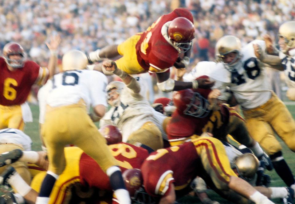 Sam Cunningham leaps over the pile against Notre Dame at the Los Angeles Memorial Coliseum during a gmae in 1972.