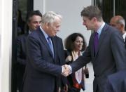 France's Foreign Minister Jean-Marc Ayrault (L) shakes hands with Greg Clark Britain's Secretary of State for Business outside 10 Carlton House Terrace in central London, where representatives from Britain, China, France and energy company EDF signed an agreement to build and operate a new nuclear power station at Hinkley Point, Britain, September 29, 2016. REUTERS/Peter Nicholls