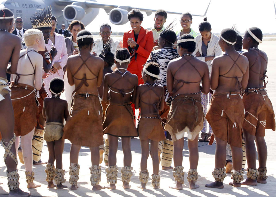 U.S. first lady Michelle Obama is greeted by traditional dancers as she arrives in Gaborone, Botswana, Friday, June 24, 2011. (AP Photo/Charles Dharapak, Pool)