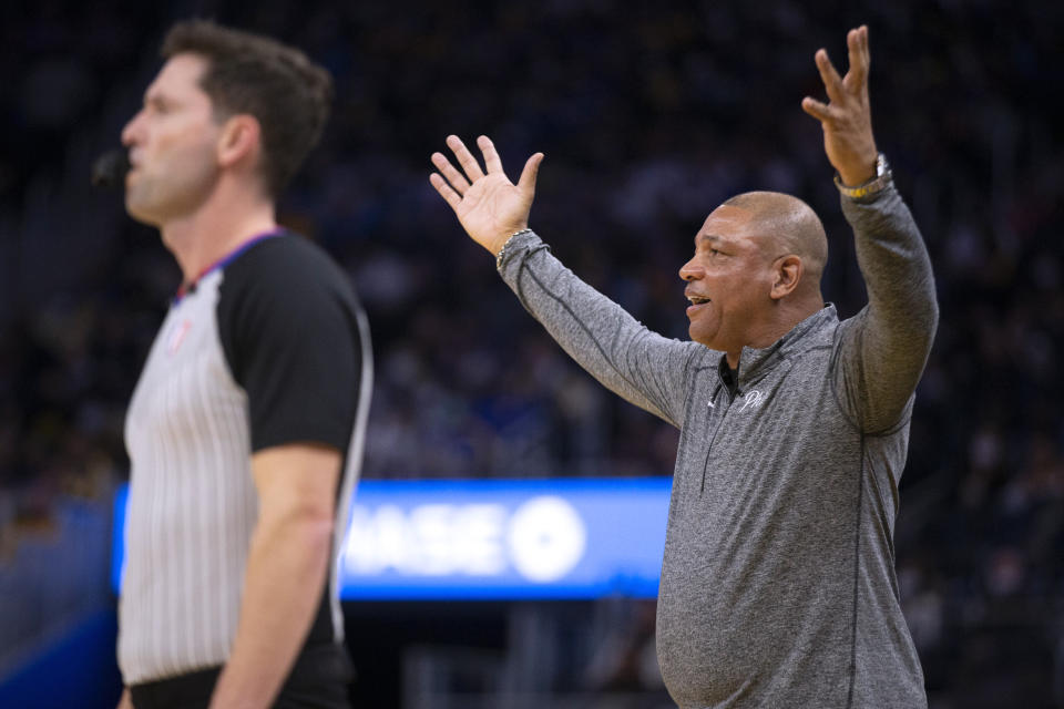 Philadelphia 76ers coach Doc Rivers, right, questions a referee's call during the first quarter of the team's NBA basketball game against the Golden State Warriors, Wednesday, Nov. 24, 2021, in San Francisco. (AP Photo/D. Ross Cameron)