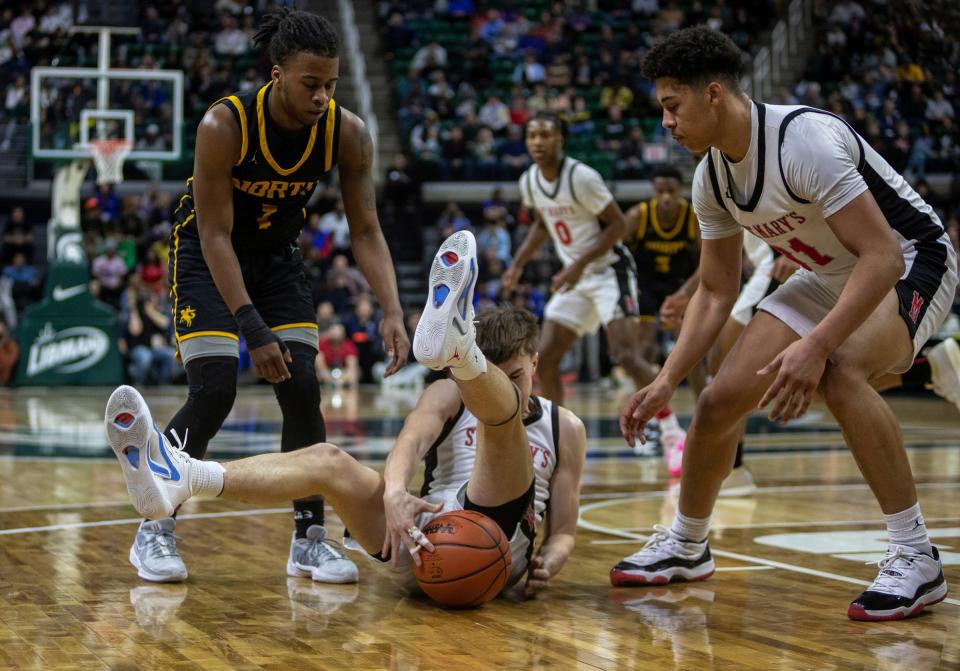 Orchard Lake St. Mary's Daniel Smythe battles for a loose ball against North Farmington during the MHSAA Div. 1 state finals at the Breslin Center in East Lansing on Saturday, March 16, 2024.