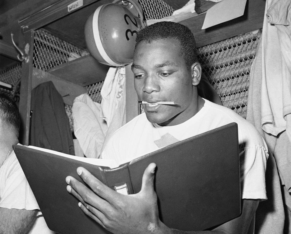 Browns running back Jim Brown studies in the dressing room before a practice, Nov. 13, 1958 in Cleveland.