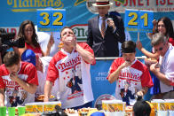 <p>Joey Chestnut, center, at the Nathan’s Famous International Hot Dog Eating Contest at Coney Island in Brooklyn, New York City, U.S., July 4, 2017. (Erik Pendzich/REX/Shutterstock) </p>