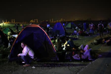 Migrants sleep in a makeshift camp near the train station in Tovarnik, Croatia, September 17, 2015. REUTERS/Antonio Bronic