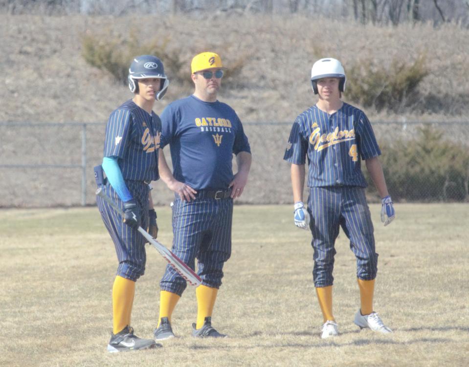 Torino Lamerato, head coach Dan Mygrants and Ethan Ford talk during a pitching change during a baseball matchup between Gaylord and Rudyard on Tuesday, April 11.