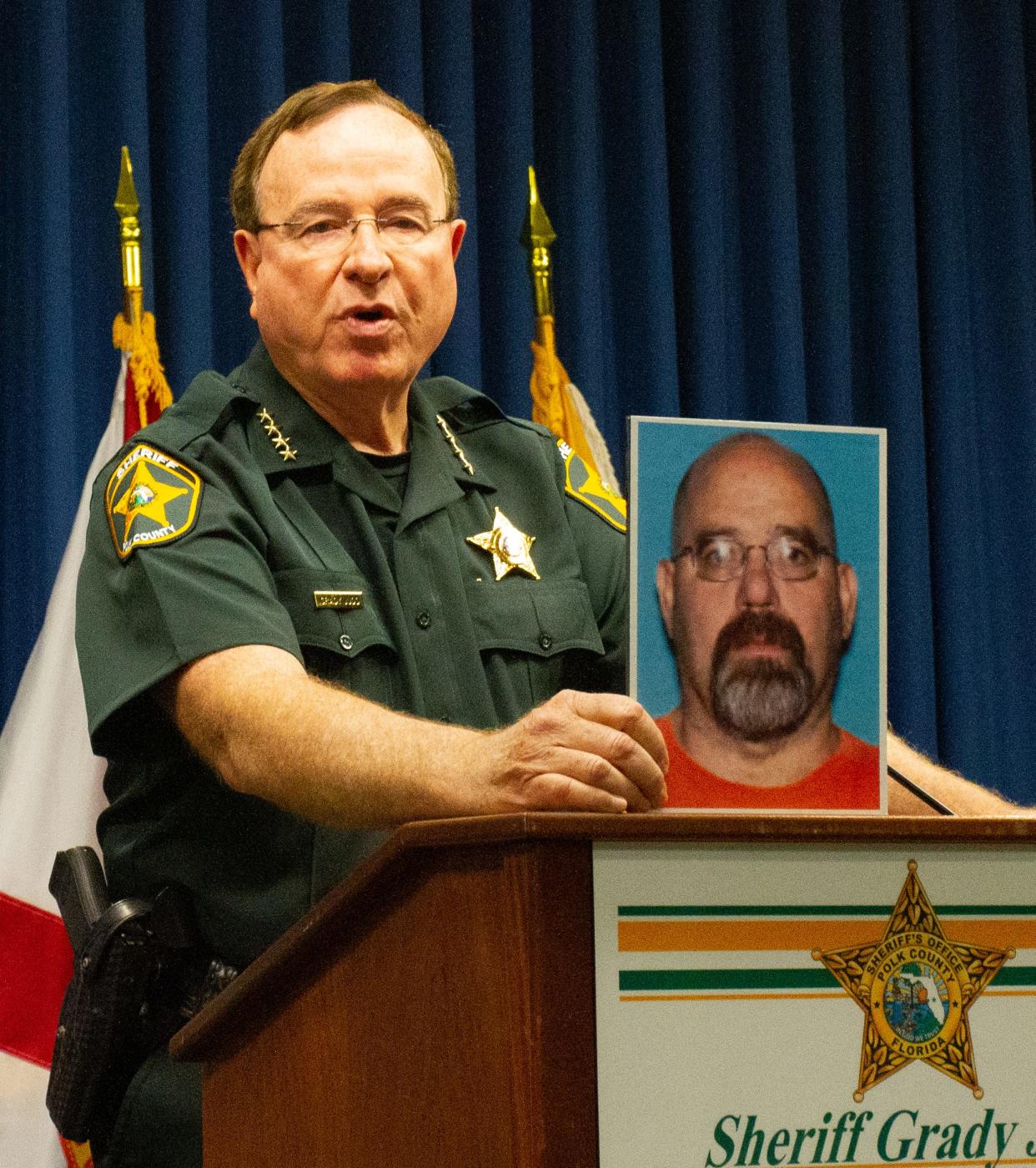 Polk County Sheriff Grady Judd holds a photo of Kevin Berry of Altamonte Springs. He was found shot on an exit ramp from Interstate 4 at U.S. 27 early Sunday morning.
