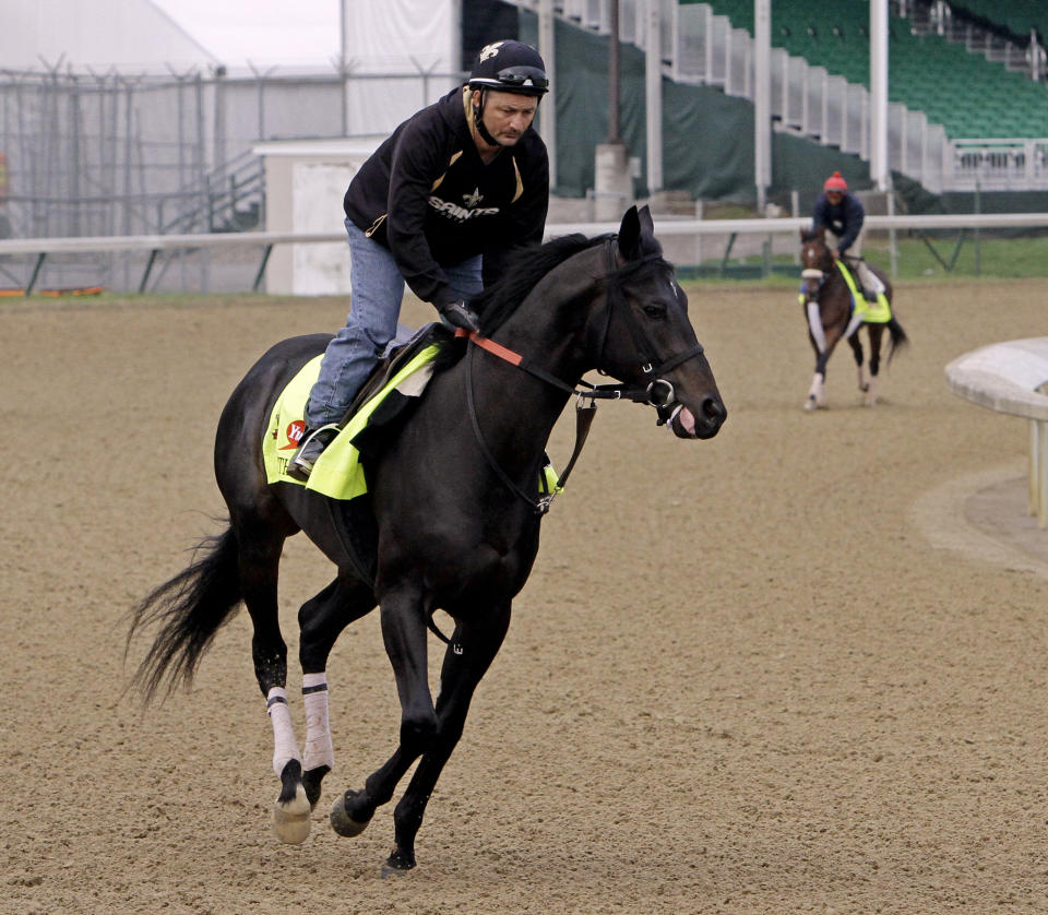 Exercise rider Issac Muniz takes Kentucky Derby hopeful Dance With Fate for a morning workout at Churchill Downs Wednesday, April 30, 2014, in Louisville, Ky. (AP Photo/Garry Jones)
